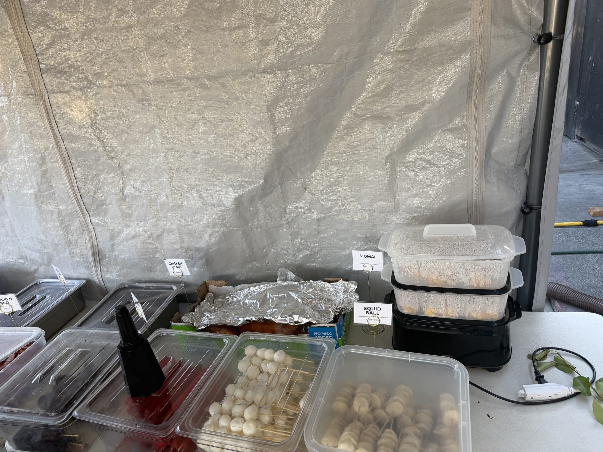 Fishballs and squid balls on sticks with the siomai steamer